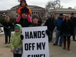 A family from Burnsville attended a rally at the State Capitol to oppose upcoming hearings on gun control legislation. Photo by nick coleman