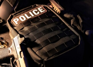 Built for the Mission: The Future of Custom Armor Systems Close-up of a police tactical vest with integrated body armor, highlighting modern ballistic protection equipment used by law enforcement in operational environments.