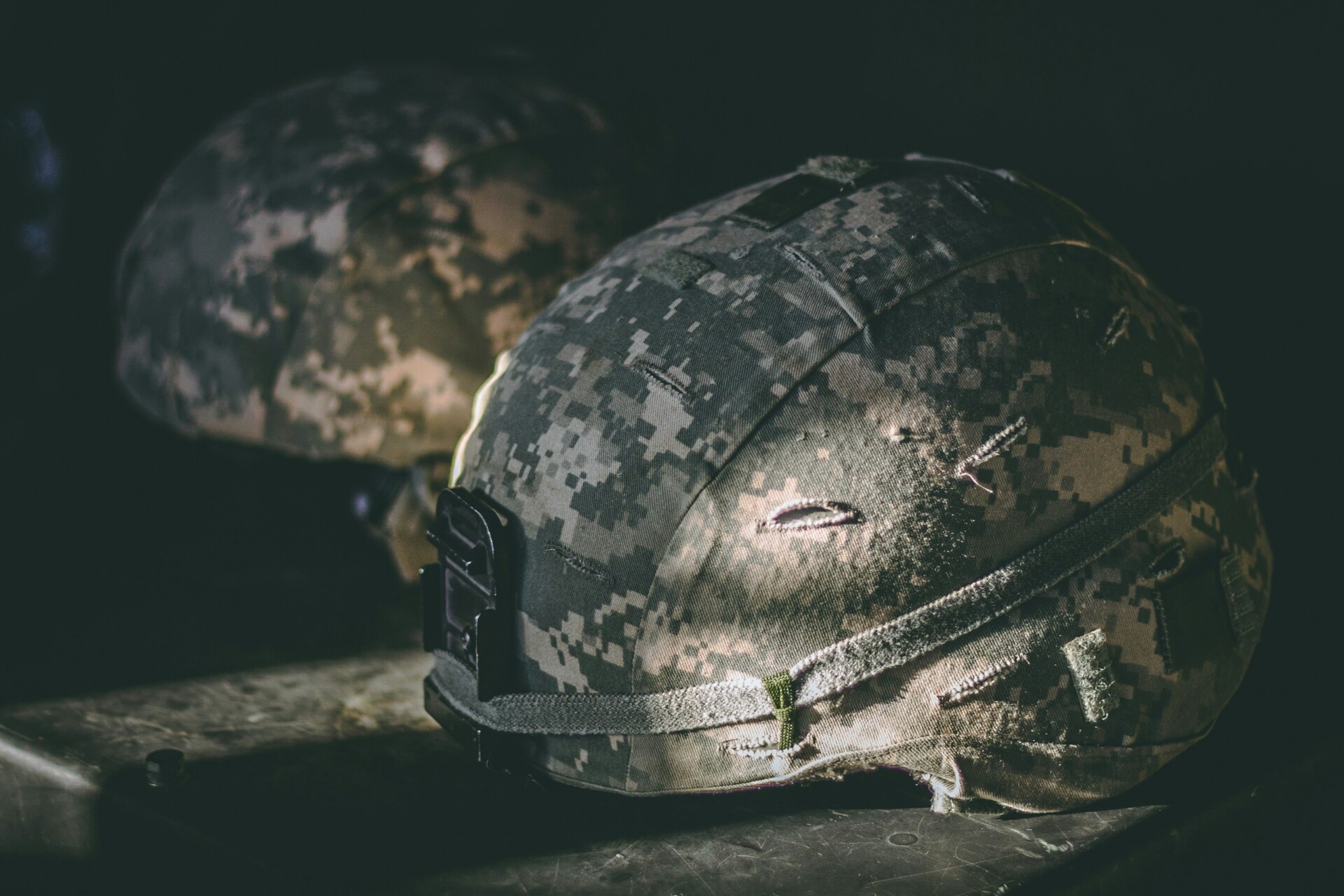 Military Ballistic Helmet Two military ballistic helmets on display, partially hit by the sun